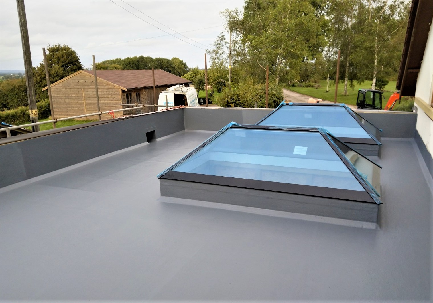 Grey Fibreglass Flat Roof with 2 lanterns/skylights.